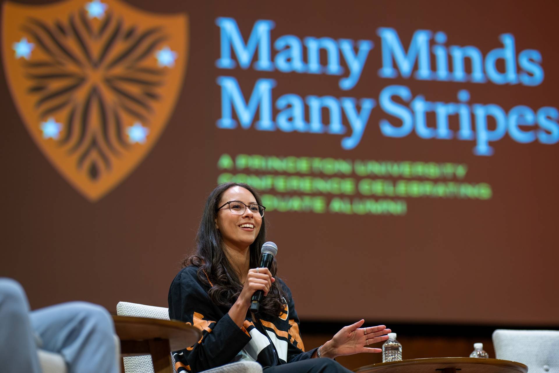 Current Princeton grad student Caridad Estrada speaks from the event stage.