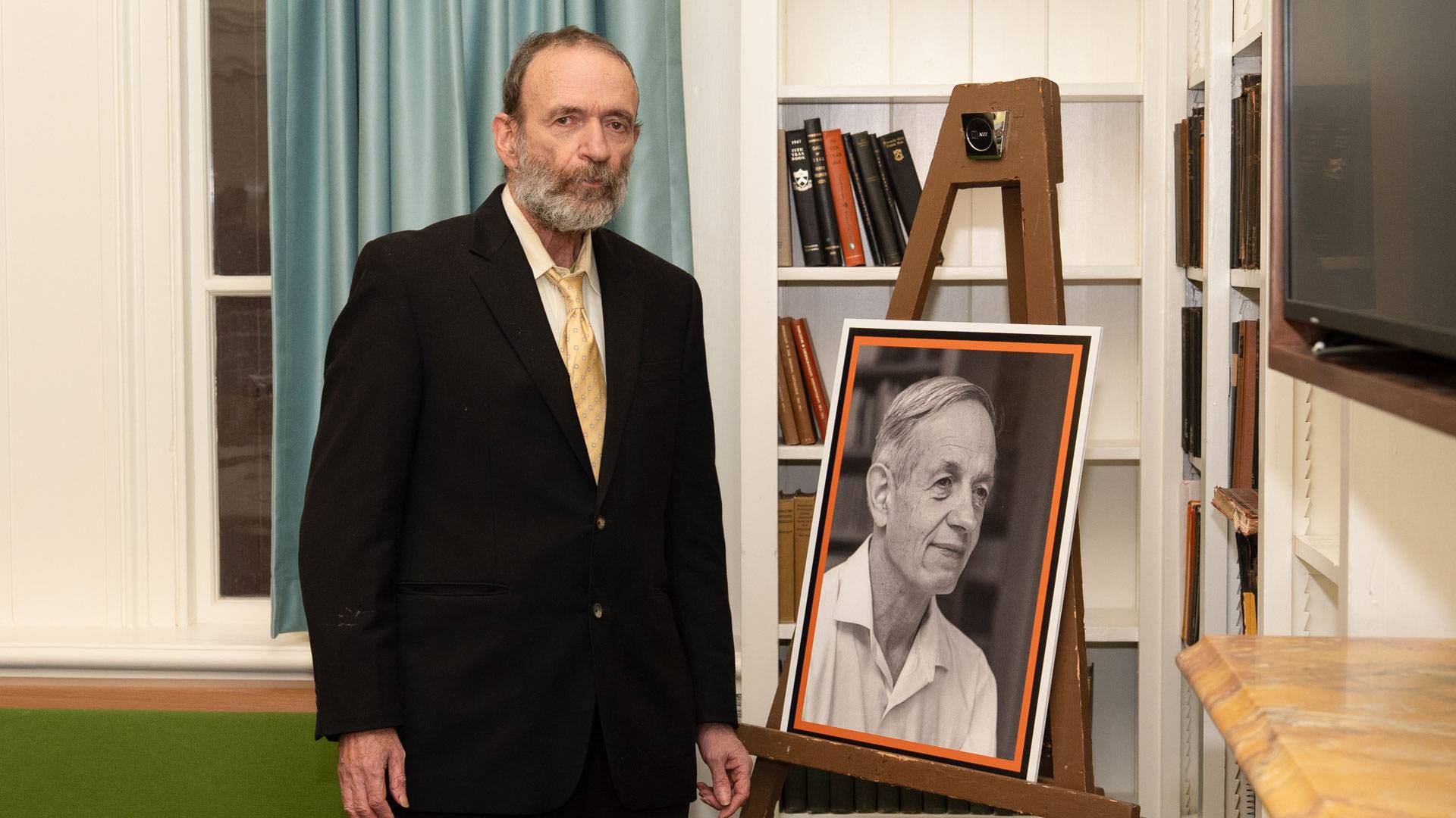 John Charles Martin Nash with a photo of his father, John Nash. 
