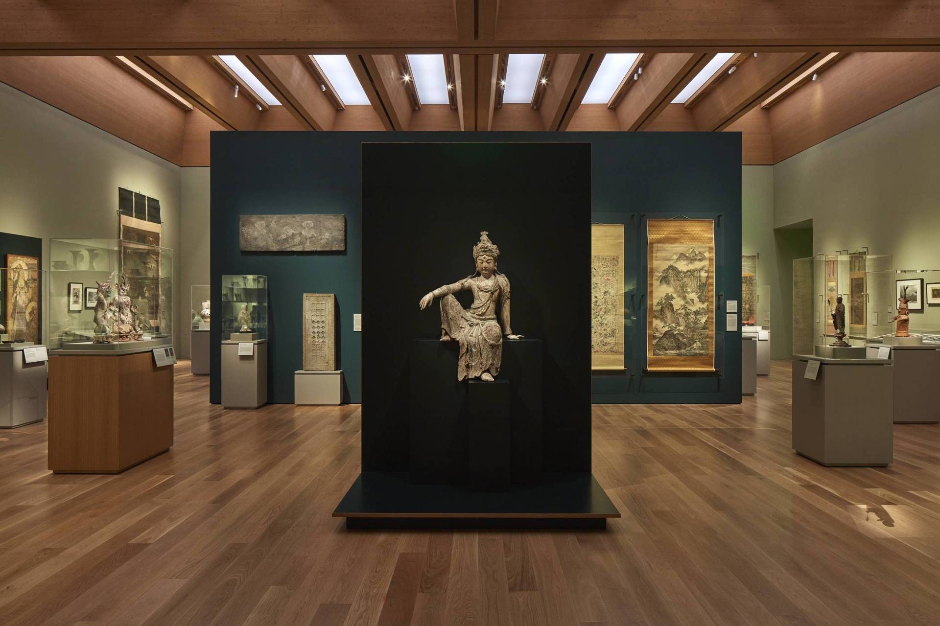 Statue depicting a Buddhist bodhisattva with arm resting on bent knee while seated