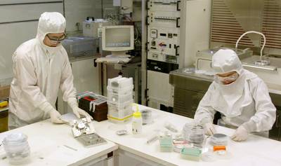 Researchers in protective suits