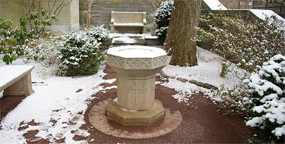 snow covered birdbath in garden