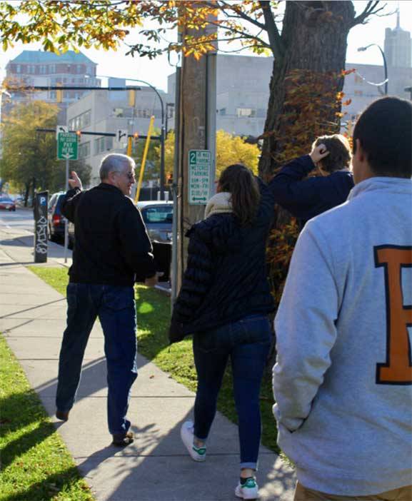 The "Refugee Resettlement: Understanding an Ongoing Journey" trip team got a first-hand look at how refugees have an impact in Buffalo, New York, through a walking tour led by Chuck Massey, a former Houghton College professor involved with refugee resettlement in the city. Here, the team is on the way to Buffalo's City Hall.