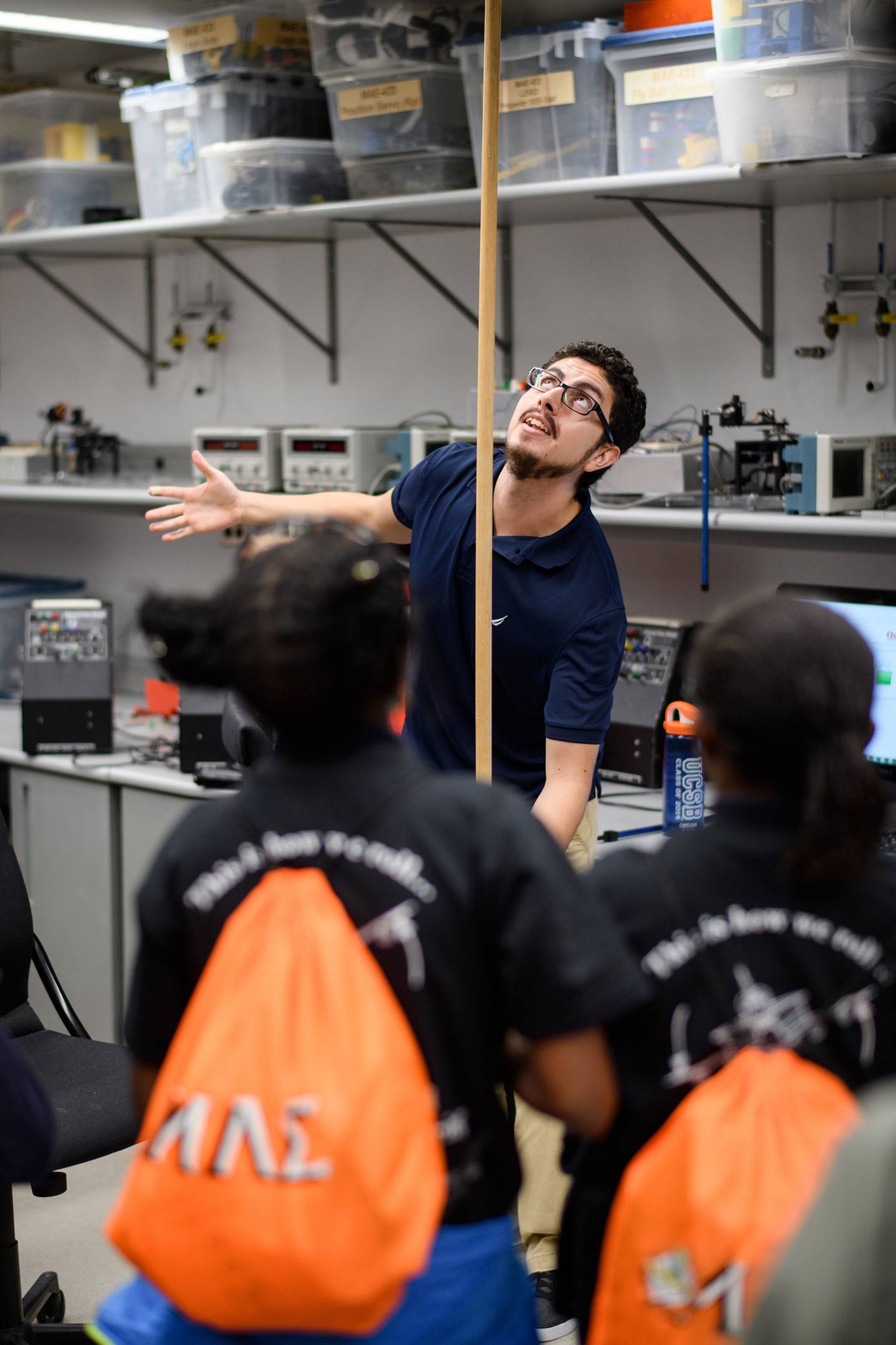 Renato Pagliara holding pole while students watch