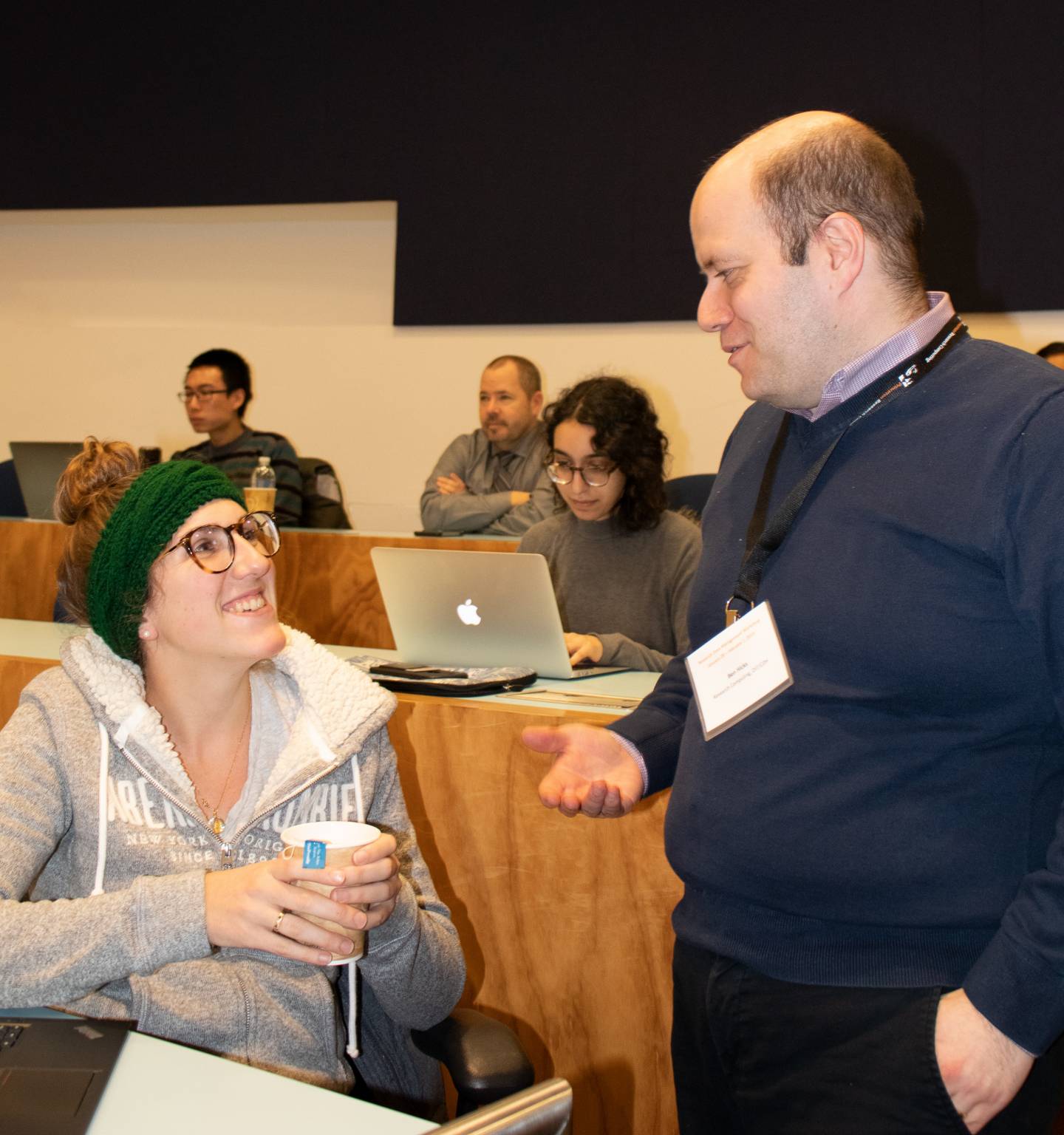 A man chats with a graduate student