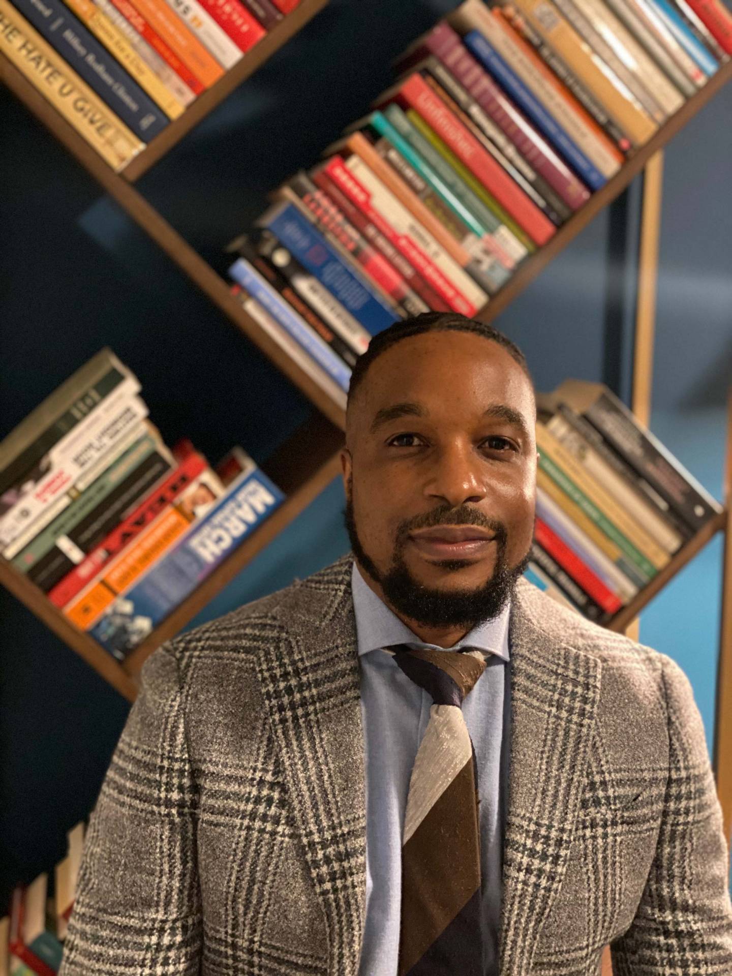 Laurence Ralph in front of his bookshelves