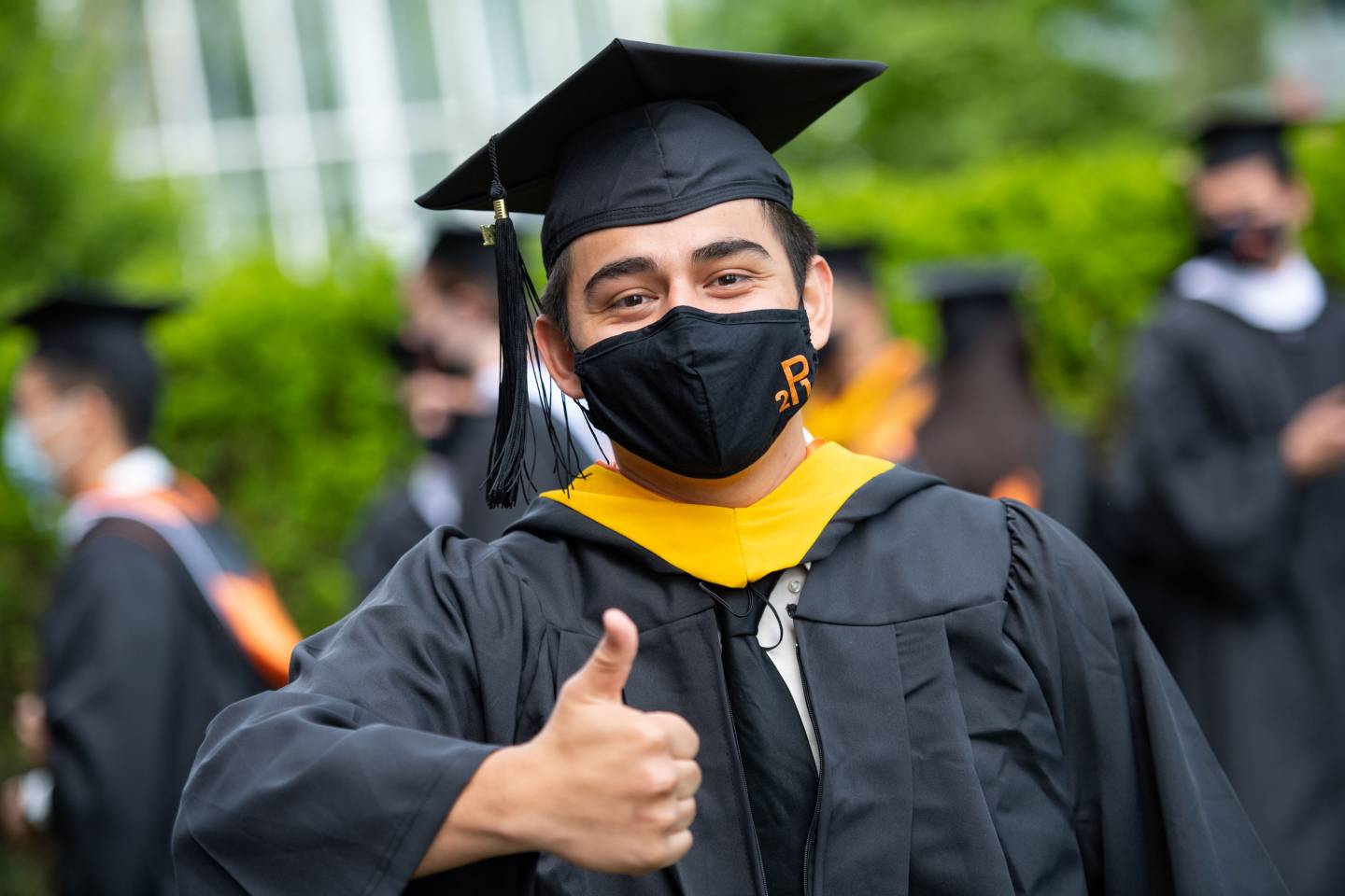 A student gives a thumbs up sign