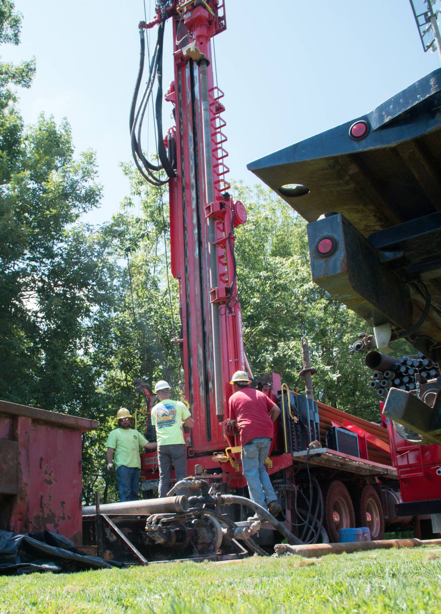 Workers operating a drill