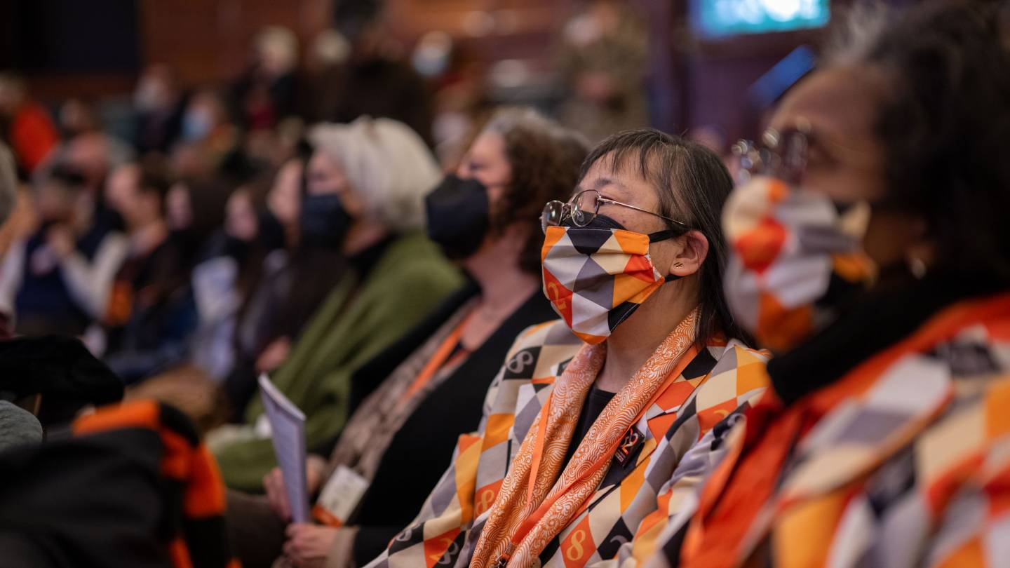 Audience wearing orange and black