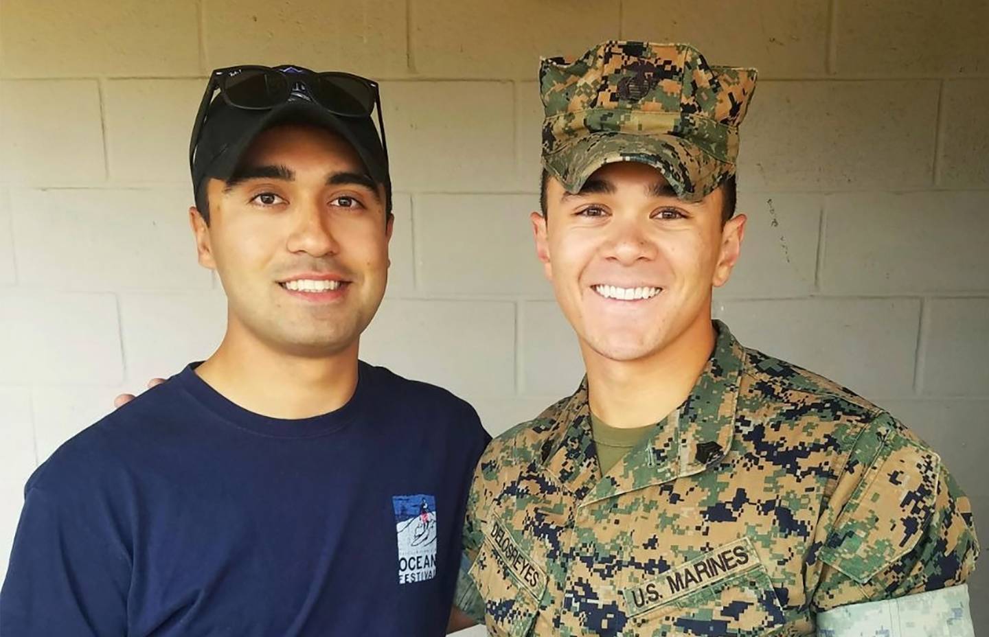 Two young men, one wearing military fatigues