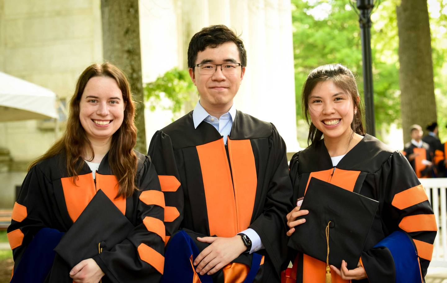 Three students awaiting the Hooding ceremony