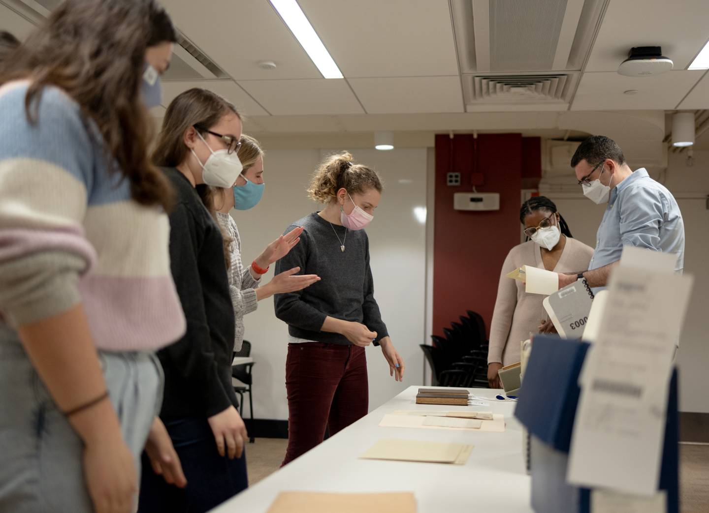 Students look at Ulysses with librarian and professor