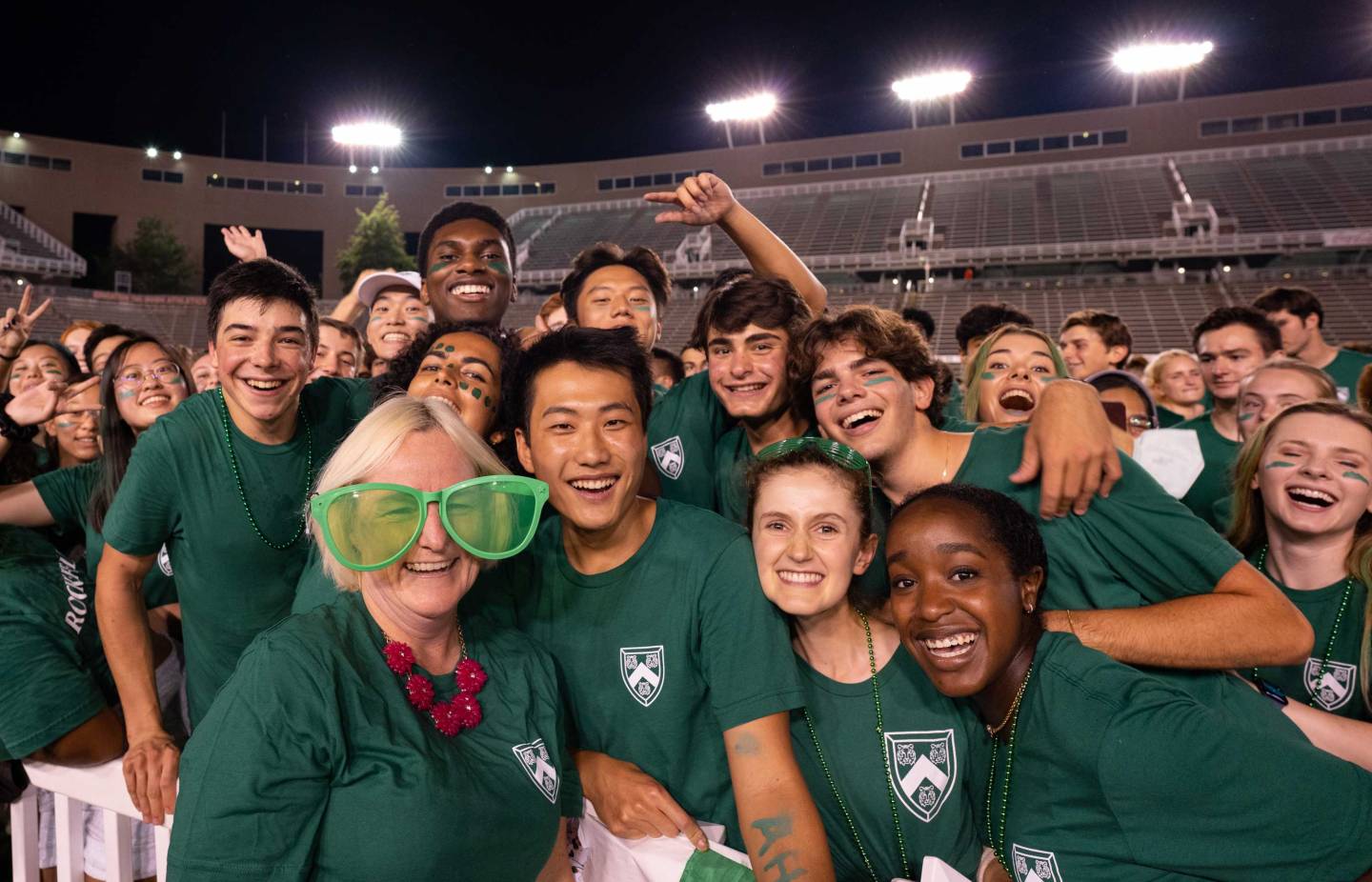 a director of student life dons oversized novelty glasses at a residential college event