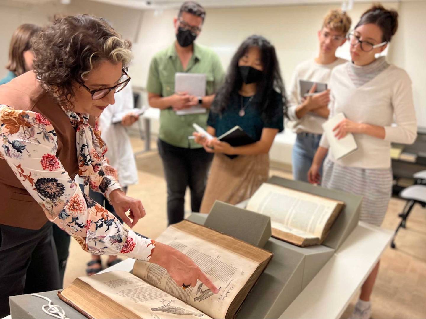 Prof DeLue points to a manuscript