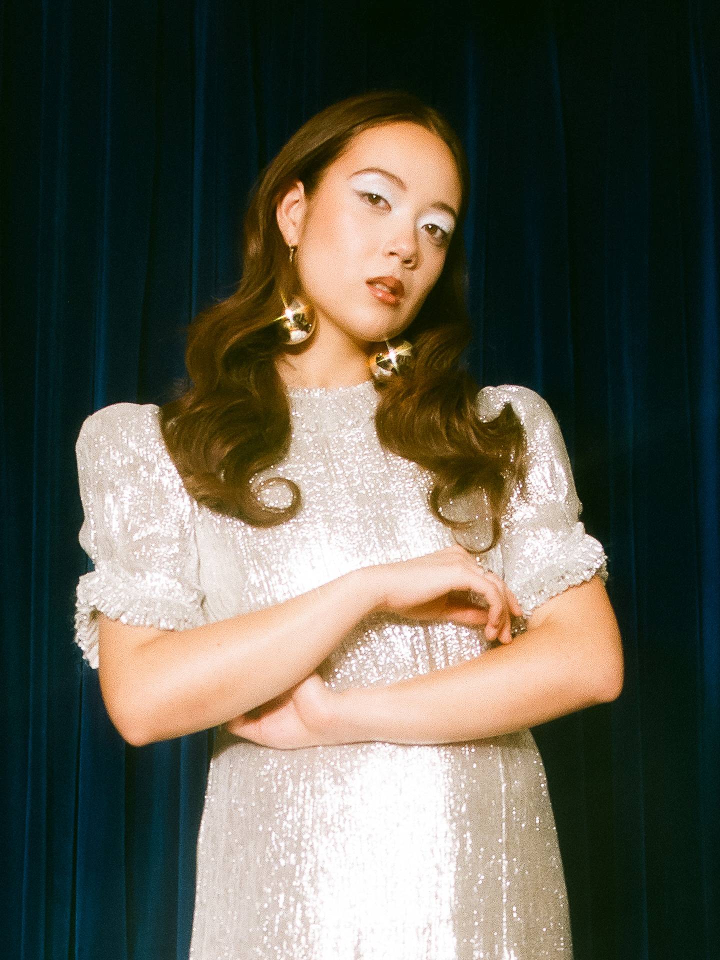 Laufey standing with arms crossed