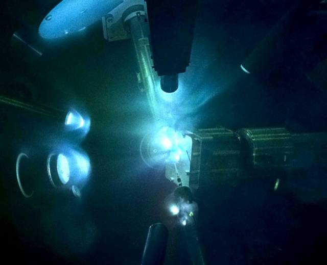 Lasers inside a target chamber compressing iron-silicon samples