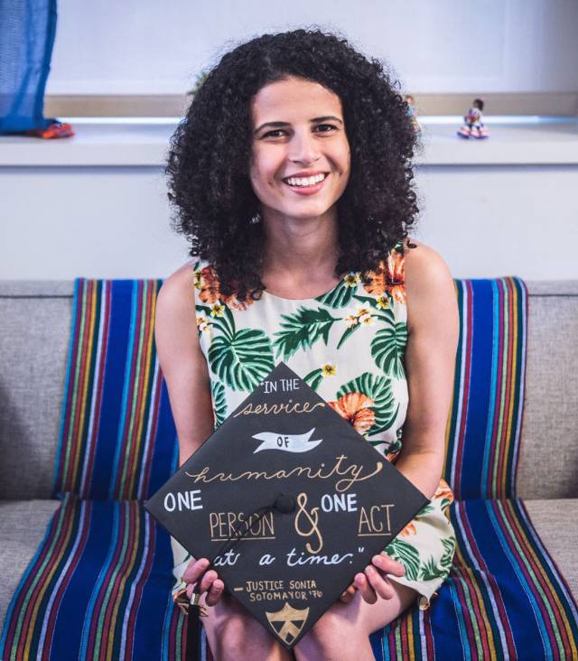 Briana Christophers holding decorated graduation cap