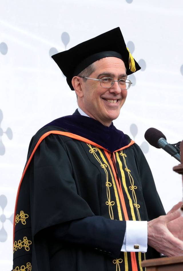 President Christopher L. Eisgruber applauds