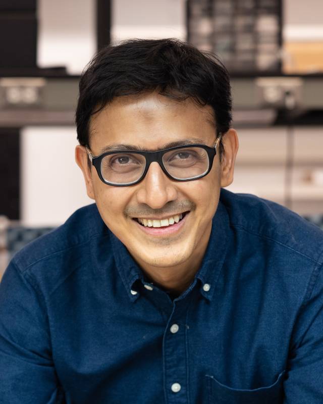 A smiling man in glasses