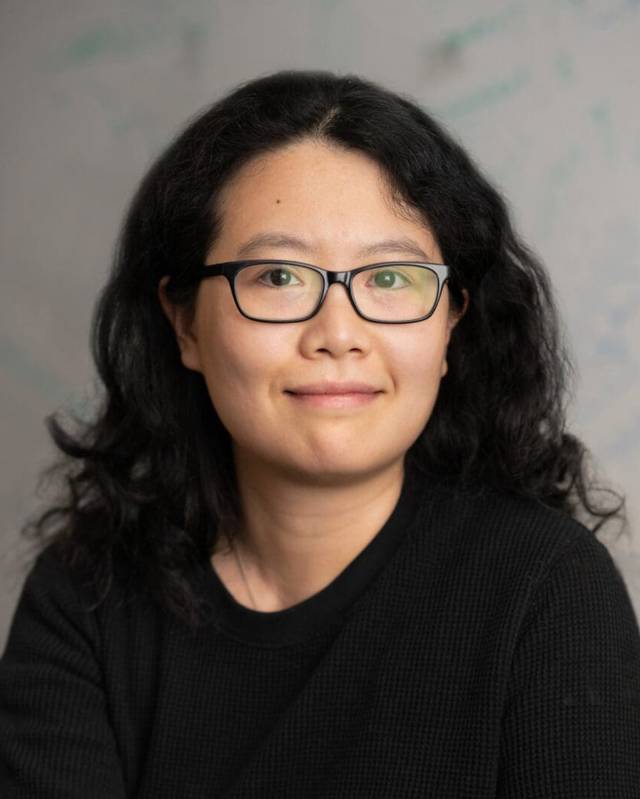 A smiling woman in glasses